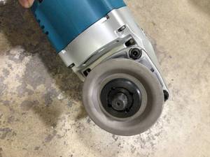 lot 11 image: Makita 15 Amp 7 in. Corded Angle Grinder with Grinding wheel, Side handle and Wheel Guard Customer Returns See Pictures