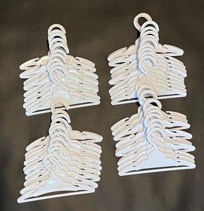 lot 186 image: 48 Plastic Hangers for American Girl Clothes