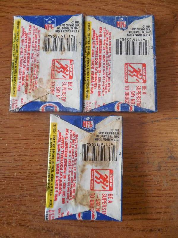 lot 50 image: (3) 1984 Topps Football Sealed Wax Packs 15 Cards