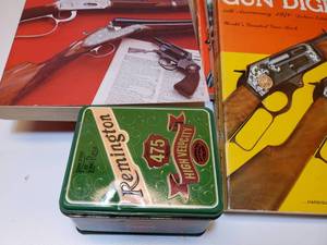 lot 152 image: 10 Gun & Fishing Books from the 1970s, along with a Remington Tin.