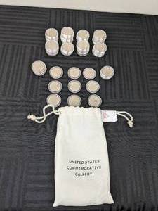 lot 23 image: (56) United States Commemorative Quarters with Protective Coin Capsules and Drawstring Bag