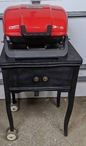 lot 82 image: Coleman Propane Tabletop Grill and Vintage Sewing Machine Table