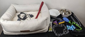 lot 107 image: Assortment of Pet Supplies Vibrant Life Pet Bed, E Collar, Leash, Brushes, Lint Rollers, & More