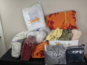 lot 142 image: An Assortment of Towels, Bedding, Room Essentials Mattress Pad, and Heated Mattress Pad