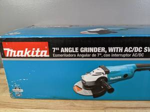 lot 16 image: Brand New Makita 15 Amp 7 in. Corded Angle Grinder with Grinding wheel, Side handle and Wheel Guard Y
