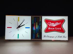 lot 21 image: Miller High Life illuminated clock with multi-color bands, retro cool