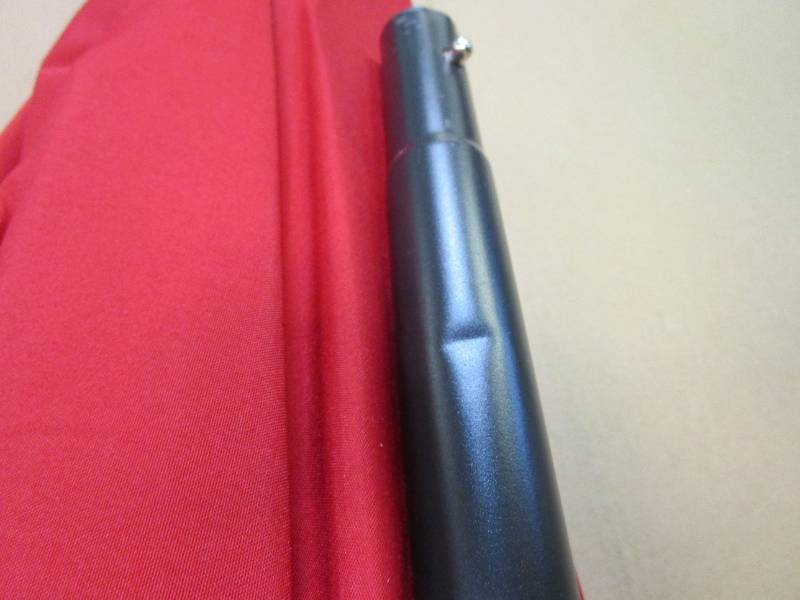 lot 371 image: Red Patio Umbrella (OPEN BOX, TINY DENT ON POLE)