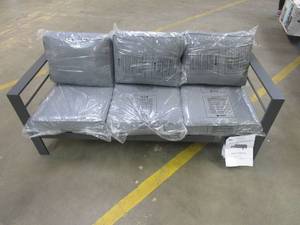 lot 173 image: Metal Patio Sofa in Dark Gray with Gray Cushions (SMALL DENT ON LEFT FOOT)