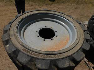 lot 22 image: 4 - Rough Terrain Foam Filled Tires on Rims