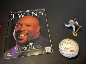 lot 201 image: Kirby Puckett & MN Twins memorabilia 2 mini bats, Twins-signed baseball, Puckett moveable figurine, Twins Mane magazine & Twins trading cards album