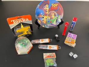 lot 173 image: fun times mix  mini Tonka truck, Toy Story, Spiderman Pez dispenser  candies, Hex Bugs, Space Walking Elephant & Felix the Cat pin