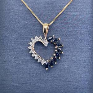 lot 33A image: Round Cut White Diamond & Marquise Cut Natural Blue Sapphire Half & Half Halo Cluster Heart Wreath Pendant in Two-Tone Yellow & White Gold $1,275 Retail