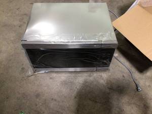 lot 26 image: LG NeoChef 24 in. Width 2.0 cu.ft. Stainless Steel 1200-Watt Countertop Microwave Damaged Customer Returns See Pictures