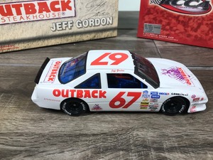 lot 19 image: 2000 Nascar Action RCCA 1990 Pontiac Jeff Gordon #67  Outback Steakhouse 124 scale die cast coin bank