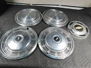 lot 396 image: 2) 197374  Pontiac, 1974 Chevy, and 1 sm. Chevy hubcaps