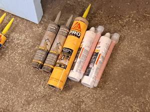 lot 322 image: Lot of (5) Assorted Adhesives and Sealants - Quikrete Concrete Repair, Sika Pro Select Self Leveling Sealant, Simpson Strong Tie Set-XP epoxy