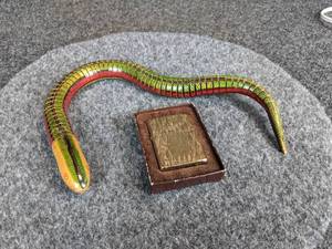 lot 491 image: Carborundum ZIPPO Lighter - Cool Carved Back  Vintage Wood Toy Moving Snake