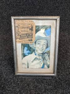 lot 511 image: 1949 Gene Autry Riders of the Whistling Pines Movie Pass - Framed with Gene Autry Photo