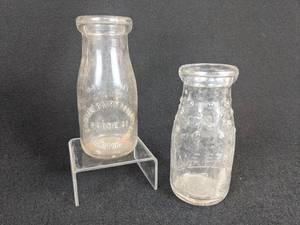 lot 569 image: Pair of Vintage Half Pint Milk Bottles - Sanitary Dairy Products of Crookston, MN and Lane Bros. Inc of Tampa, FL