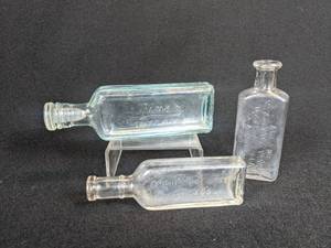 lot 576 image: Lot of (3) Vintage Glass Bottles - PineX (With Glass Stopper), Arbuckle Brothers, and McMurrays Vanilla