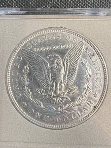 lot 23 image: 1886 US MORGAN SILVER DOLLAR IN PLASTIC CASE