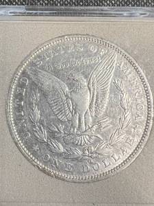 lot 48 image: 1888-O US MORGAN SILVER DOLLAR IN PLASTIC HOLDER