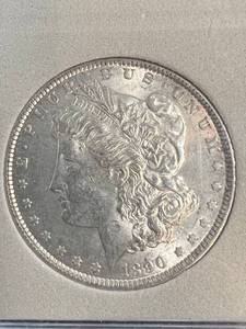 lot 70 image: 1890 US MORGAN SILVER DOLLAR AU IN PLASTIC HOLDER