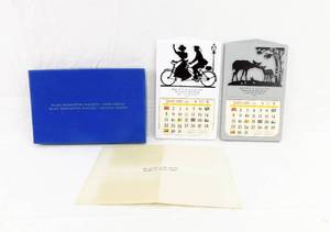 lot 36 image: Lot of 2 Vintage 1956 Silhouette Placque Calendars in Salesman Sample Box