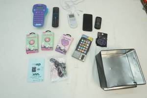 lot 73 image: Black tin , old phones