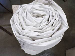 lot 104 image: Large Tarp Good for Woodpile may have holes or rips