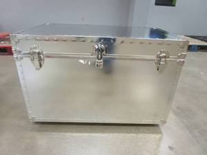 lot 328 image: Biltmore Smooth Steel Trunk with Wheels - Silver, Trim is slightly loose on one side (See Photos).
