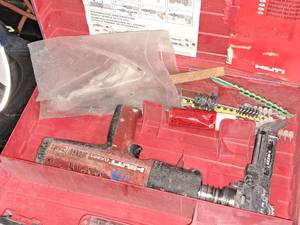 lot 21 image: Hilti Fully Automatic Powder-Actuated Nailer DX351 with Nail Magazine X-MX32, Accessories and a Plastic Carry Case
