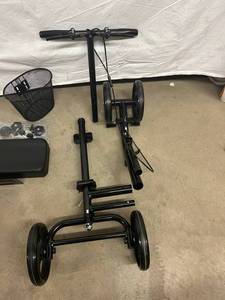 lot 20 image: We Believe This Is A&nbspKneeRover Knee Scooter Steerable Knee Walker - Crutch Alternative with DUAL BRAKING SYSTEM in Matte Black With Basket - Unknown If All Parts Are There...