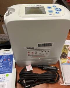 lot 6 image: MSRP $2800 Inogen 1 g5 Portable Oxygen Concentrator - Selling For Parts Only  Batteries Are Dead, Missing Part Inside That We Think Is a Big Filter - Concentrator Looks Used But Bag & Car Plug In Look Unused - Comes With Original Box