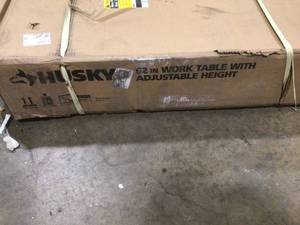 lot 9 image: Husky 62 in. W x 24 in. D Adjustable Height Solid Wood Top Workbench Table in Black  Customer Returns  See Pictures