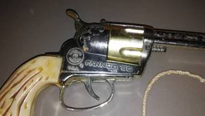 lot 903 image: Toy Revolver And Leather Holster,