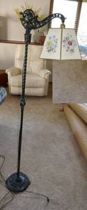 A unique metal floor lamp with cardboard lamp shade