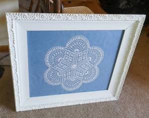 Two vintage frames with doilies