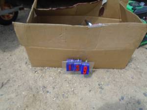 lot 139 image: Box of Harley Davidson exhaust pipes, mufflers, air cleaner parts & wheel chock. As shown.