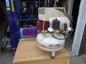 lot 144 image: Tool Shop pancake air compressor. Good used condition. Tested & works. Doesnt leak down. As shown.