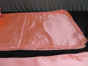 lot 93 image: CORAL SATIN RUNNERS AND CHAIR SASHES