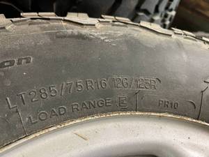 lot 87 image: 4 LT28575R16 All-Terrain Tires on Jeep 5 Lug Rims