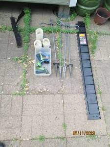 lot 32 image: Garden hose sprayers, stake-style plant hangers, garden edging, flame less candles