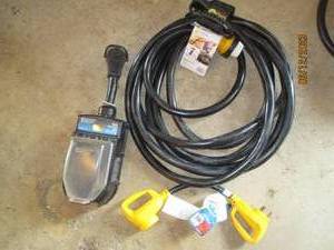 lot 52 image: 50 amp RV electric power cord, 30 amp to 50 amp electric power adaptor and 50 amp power surge protector