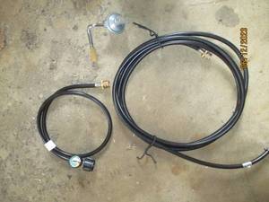 lot 100 image: Propane adapter hoses and regulator...