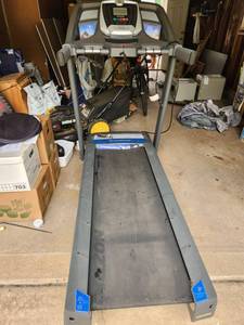 lot 3 image: Horizon T101 Quiet Drive Fearher Light Treadmill, has wheels for easy moving, folds up when not in use, and auto slow release ramp back to the ground for use