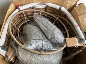 lot 105 image: StyleWell Brown Wicker Outdoor Swivel Patio Egg Lounge Chair with Beige Cushions and BlackCream Pattern Pillows