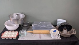 lot 42 image: Assorted Baking Items - Bundt Pan, The Pioneer Woman Egg Holder, Loaf Pans, The Pampered Chef Pastry Mat, Rolling Pin, and more