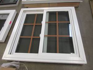 lot 16 image: Simonton 40 in x 38.5 in Slider Window - Internal Woodgrain Grille - Interior is White Vinyl - Exterior is Bronze  (SLIGHT SCRATCHES, RIP IN THE SCREEN)