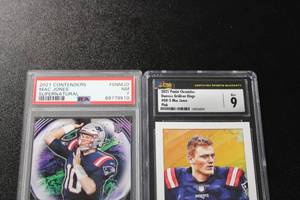 lot 152 image: 2021 Chronicles Gridiron Kings Pink Mac Jones CSG 9 & 2021 Contenders Supernatural Mac Jones PSA 7